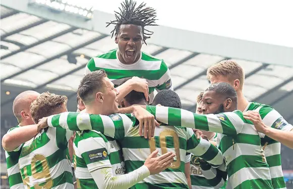  ??  ?? HAPPY HOOPS: The Celtic players celebrate with Moussa Dembele, number 10, after he scored a penalty to make it 3-0 at Hampden against Rangers yesterday