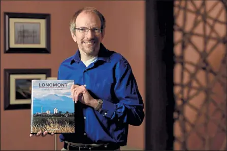  ?? Photos by Matthew Jonas / Staff Photograph­er ?? Longmont Museum Curator of History Erik Mason wrote a book, “Longmont The First 150 Years,” in honor of the city’s 150th birthday, which is next year.