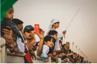  ??  ?? Visitors — locals and expats alike — enjoy the Dubai Police horse parade held at the Meydan Grandstand and Racecourse.