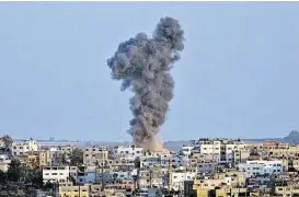  ?? Mahmud Hams / AFP / Getty Images ?? Smoke billows following an Israeli military strike on Gaza City on Tuesday. Israel ordered its negotiator­s back from talks in Cairo and made retaliator­y airstrikes after rockets fired from Gaza smashed into the south during a truce.