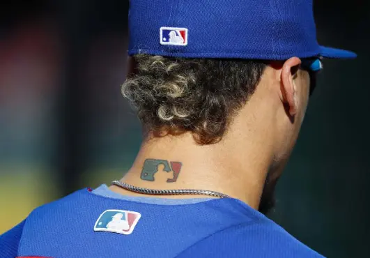  ?? Pablo Martinez Monsivais, The Associated Press ?? Then-chicago Cubs infielder Javier Baez sports an MLB logo tattoo and logos on his hat and jersey as he waits to take batting practice during the 2017 MLB playoffs at Nationals Park in Washington.