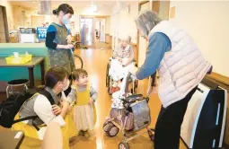  ?? ICHOAN NURSING HOME ?? An Ichoan Nursing Home “baby worker” interacts with residents. They get paid in formula and diapers in a program that connects people across generation­s.