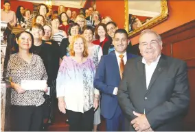  ?? NICK BRANCACCIO ?? WFCU executives Marty Gillis, right, and Eddie Francis gather with recipients of the 2019 Community Donations Fund at Willistead Manor on Friday.