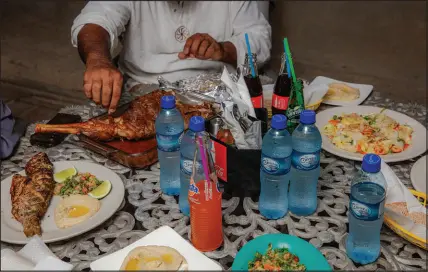  ?? ?? Above, Khan celebrates one night of Ramadan with his family in Belize City, where his family has relocated from Pakistan. At right, Khan’s daughter, Manaal, now 20, did not meet her father until he was released from prison last year.