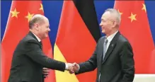  ?? ANDY WONG / AFP ?? Vice-Premier Liu He shakes hands with German Vice-Chancellor Olaf Scholz at the China-Germany High Level Financial Dialogue at Diaoyutai State Guesthouse in Beijing on Friday.