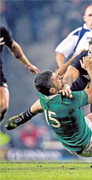  ??  ?? Getting physical: New Zealand’s TJ Perenara is tackled by Ireland full-back Rob Kearney