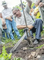  ?? PABLO COZZAGLIO / AFP / GETTY IMAGES ?? Ecuadorian Jose Conte digs up oil slime on his land in September 2017 near an area contaminat­ed with oil from a now abandoned well in the Ecuador rain forest.