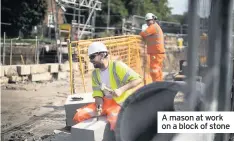  ??  ?? A mason at work on a block of stone