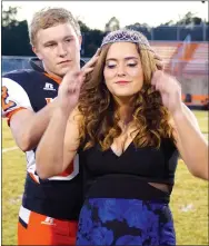  ?? Photo by Randy Moll ?? Bret Callahan places the queen’s crown on the head of Alex Krewson at Gravette High School homecoming ceremonies in Lion Stadium on Oct. 21.