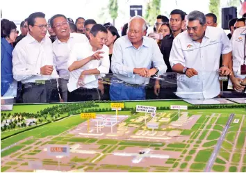  ??  ?? Najib with Jack Ma viewing a scaled model of the Digital-Free Trade Zone near Kuala Lumpur Internatio­nal Airport. - Bernama photo