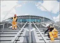  ?? PICTURE: PA ?? ACTIVITY: Workers put the finishing touches to the Olympic Steps in London, a sign the economy is starting to return to growth.