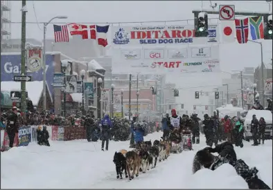  ?? Photo by RB Smith ?? 50 YEARS OF IDITAROD— Aaron Burmeister of Nome leaves the start line during the ceremonial start in Anchorage, on Saturday, March 5.