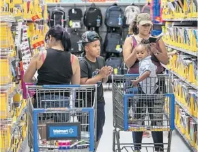  ?? JACOB LANGSTON/STAFF PHOTOGRAPH­ER ?? Families shop for school supplies early Tuesday at a Walmart store on East Colonial Drive in Orlando. Florida’s annual tax-free, back-to-school shopping weekend starts Friday.