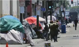  ??  ?? Tents housing homeless people line a street in downtown Los Angeles. Photograph: Richard Vogel/AP