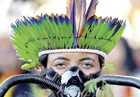  ?? AFP ?? CLIMATE PROTEST. An indigenous woman participat­es in a protest march during the Terra Livre Indigenous camp in Brasilia on April 26. The camp will run until April 29 and is focused on raising awareness about indigenous rights and land issues and promoting indigenous culture.