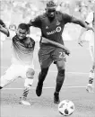  ?? TORONTO STAR FILE PHOTO ?? FC Dallas’ Reggie Cannon, left, battles with TFC defender Chris Mavinga on May 25. .