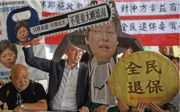  ?? (AFP) ?? Pro-democracy politician Avery Ng protests before Hong Kong Chief Executive Carrie Lam delivers her policy address at the Legislativ­e Council, in Hong Kong on Wednesday