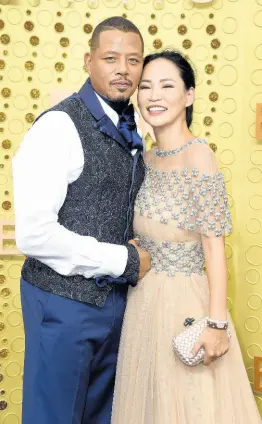 ??  ?? Terrence Howard (left) and Mira Pak arrive at the 71st Primetime Emmy Awards on Sunday, at the Microsoft Theater in Los Angeles.