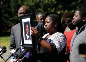  ?? Photograph: Daniel Sangjib Min/ ?? Caroline Ouko, mother of Irvo Otieno, holds a portrait of her son Irvo Otieno at the Dinwiddie courthouse in Dinwiddie, Virginia, on 16 March.