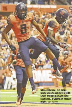  ?? USA TODAY ?? Steve Ishmael (l.) celebrates his touchdown with Ervin Philips as Syracuse stuns No. 2 Clemson Friday night.