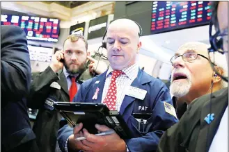  ??  ?? Traders Patrick Casey (center), and Peter Tuchman (right), work on the floor of the New York Stock Exchange, on Feb 8. Stocks opened lower on Wall Street as a mixed bag of earnings reports didn’t inspire investors to get backto buying stocks. (AP)