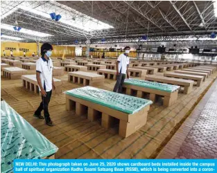  ?? — AFP ?? NEW DELHI: This photograph taken on June 25, 2020 shows cardboard beds installed inside the campus hall of spiritual organizati­on Radha Soami Satsang Beas (RSSB), which is being converted into a coronaviru­s care center.