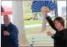  ?? MICHILEA PATTERSON — DIGITAL FIRST MEDIA ?? Tai Chi instructor­s Stewart Cleaver and Betsy Chapman use fans during a demonstrat­ion at Boyertown Community Park.