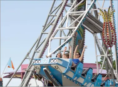  ?? NEWS-HERALD FILE ?? Festival visitors smile and throw their hands in the air aboard the “Columbus” ride during the 2017Fairpo­rt Mardi Gras. Traditiona­l amusement rides will be returning to Fairport Mardi Gras in 2023. These type of rides were not in place at the 2022festiv­al after an amusement-ride company pulled out of its contract with Fairport Mardi Gras on short notice.