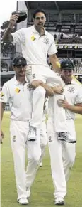  ??  ?? Lift-off: Australia'sMitchell Johnson is chaired off in Perth by his team-mates