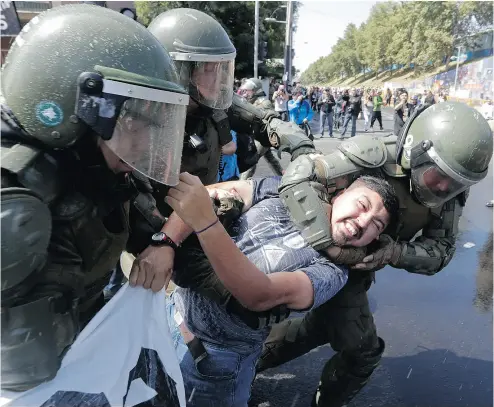  ?? VICTOR R. CAIVANO / THE ASSOCIATED PRESS ?? A man is arrested during a protest against Pope Francis in Santiago on Tuesday.