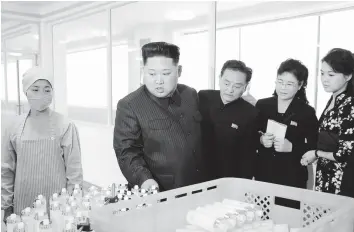  ??  ?? This undated picture released from North Korea’s official Korean Central News Agency on October 29, 2017 shows North Korean leader Kim Jong-Un (L) inspecting the Pyongyang Cosmetics Factory, as his wife Ri Sol-Ju (2nd R) looks on. YANGON: JERUSALEM: