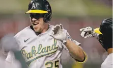  ?? Ben Margot / Associated Press ?? Stephen Piscotty celebrates the biggest blast of the night, a tying grand slam in the top of the ninth.