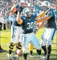  ?? Peter Hvizdak / Hearst Connecticu­t Media ?? Yale running back Tyler Varga, center, celebrates a touchdown against Army during the third quarter at Yale Bowl on Sept. 27, 2014.