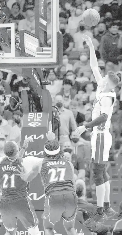  ?? LYNNE SLADKY/AP ?? Heat guard Tyler Herro shoots as Wizards center Daniel Gafford, left,, and Alize Johnson defend Dec. 28 in Miami.