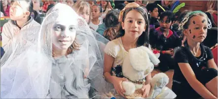  ??  ?? Otherworld­ly: Kasie Fowler, 9, won a prize for her Daisy the Ghost Princess costume, inspired by a story called Crumbly Castle. Ella Smith, 8, came dressed as Alice in Wonderland.