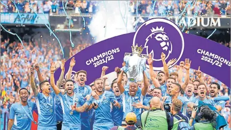  ?? AP ?? Manchester City players celebrate with the trophy after winning the Premier League at the Etihad Stadium in Manchester on Sunday.