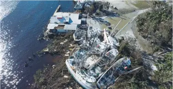  ?? (Marco Bello/Reuters) ?? SHRIMP BOATS slammed together by Hurricane Ian in Florida’s Fort Myers marina on Friday.