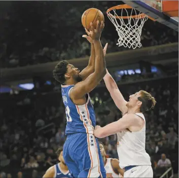  ?? AP photo ?? Philadelph­ia’s Joel Embiid Sunday in New York. shoots over New York’s Luke Kornet during the first half