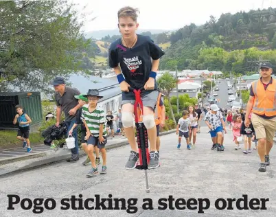  ?? Picture / Stephen Jaquiery ?? Harry Willis (11) bounces his way up the world’s steepest street on a pogo stick yesterday.