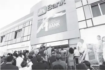  ??  ?? The JN Bank logo is unveiled at the launch of the commercial bank on February 1.