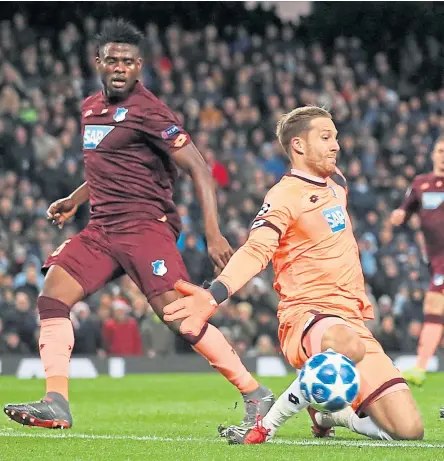  ?? Pictures: PA/ AP. ?? Above: Leroy Sane slots the ball past Hoffenheim goalkeeper Oliver Baumann for his and Manchester City’s second goal in their Group F clash at the Etihad Stadium; Manchester United striker Romelu Lukaku gets away from Valencia’s Denis Cheryshev at the Mestalla.