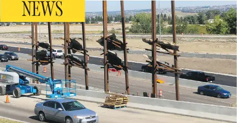  ?? PHOTOS: GAVIN YOUNG / POSTMEDIA NEWS ?? The Bowfort Towers on Calgary’s Trans-Canada Highway were created by artist Del Geist using steel beams with rock suspended within. The controvers­ial installati­on has been a lightning rod for criticism over the place of public art, and whether it...