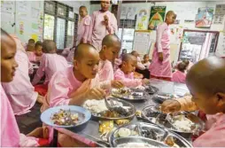  ??  ?? Buddhist nuns having breakfast at the Mingalar Thaikti nunnery.