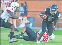  ?? Steven Eckhoff ?? Coosa’s Terry Curry (5) keeps an eye on Bowdon’s Ben Fortson as he runs the ball during Friday’s scrimmage at Eagle Stadium.