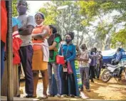  ?? Hajarah Nalwadda Associated Press ?? UGANDANS line up for vaccines in Kampala in 2022. Getting vaccines to poorer nations is a focus of talks.