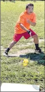  ?? (NWA Democrat-Gazette/ Randy Moll) ?? Vang spins a top as he practices before a game of Tuj Lub.