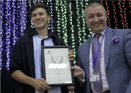  ?? Satish Kumar for The National ?? Roy Hayyat who scored the highest mark for Edexcel GCSE in French, is given his award by principal Andrew Thomas at Al Ain English Speaking School