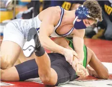  ?? APRIL GAMIZ/THE MORNING CALL ?? Notre Dame’s Holden Garcia, top wrestles Pen Argyl’s Gian Greggo in a 160 lbs match during the quarterfin­als of the District 11 2A wrestling tournament at Charles Chrin Community Center of Palmer Township.