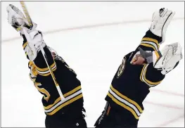  ?? MICHAEL DWYER — THE ASSOCIATED PRESS ?? The Bruins' Linus Ullmark, left, celebrates with fellow goalie Jeremy Swayman after defeating the New York Islanders on Saturday in Boston. Ullmark stopped 26 shots.