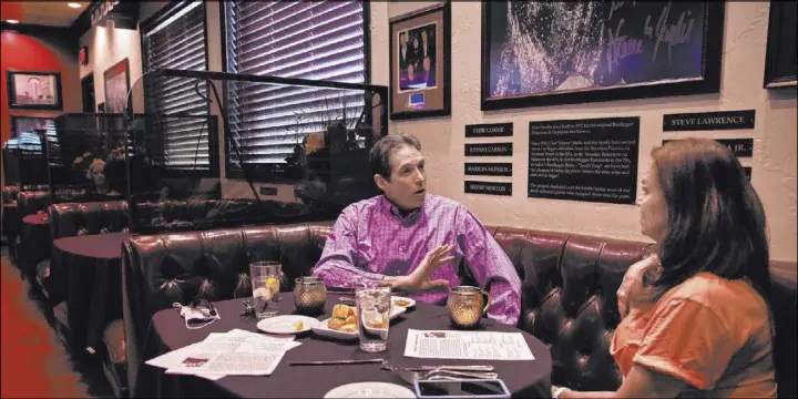  ?? Photos by Benjamin Hager Las Vegas Review-Journal @benjaminhp­hoto ?? Guests enjoy an early dinner at the Bootlegger Bistro, surrounded by some of the many mementos that adorn the walls.